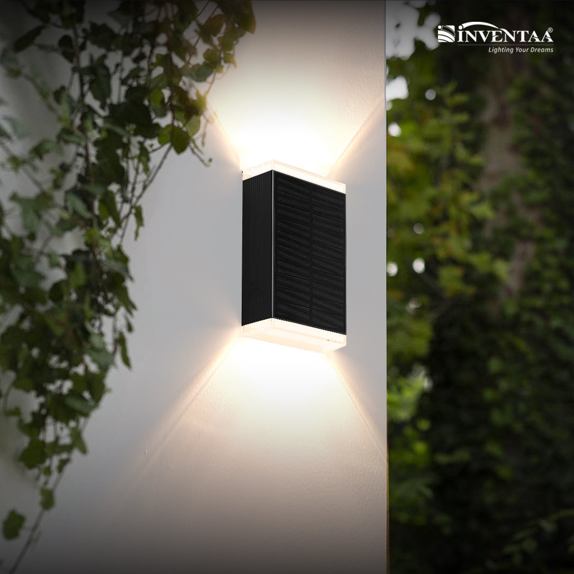 Inventaa outdoor wall light fixture on a white wall with greenery around