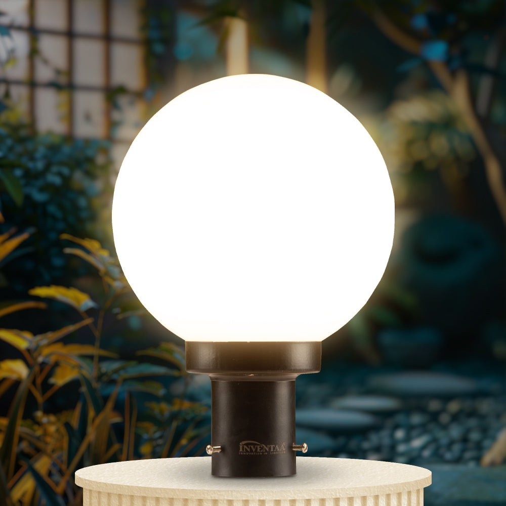 Globe-style lights for door entrance mounted on pillars at modern house